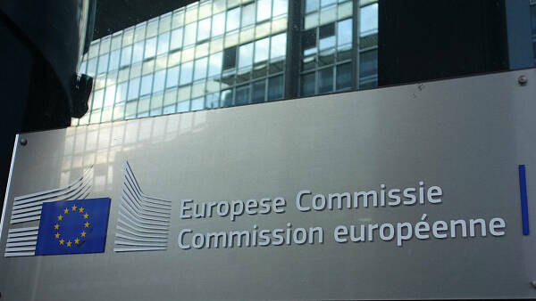 Themenbild: Schriftzug und Logo der EU-Kommission auf einem metallenen Schild vor einem Gebäude